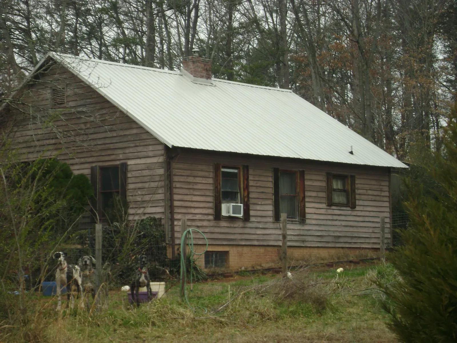 White metal roof on an old wood sided farmhouse, from a Metal Roof Installation job in North Woodstock